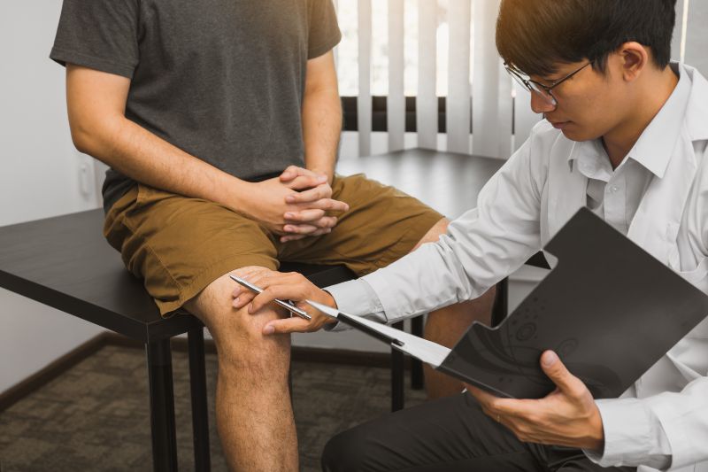 Physical therapist examining the results of knee treatments